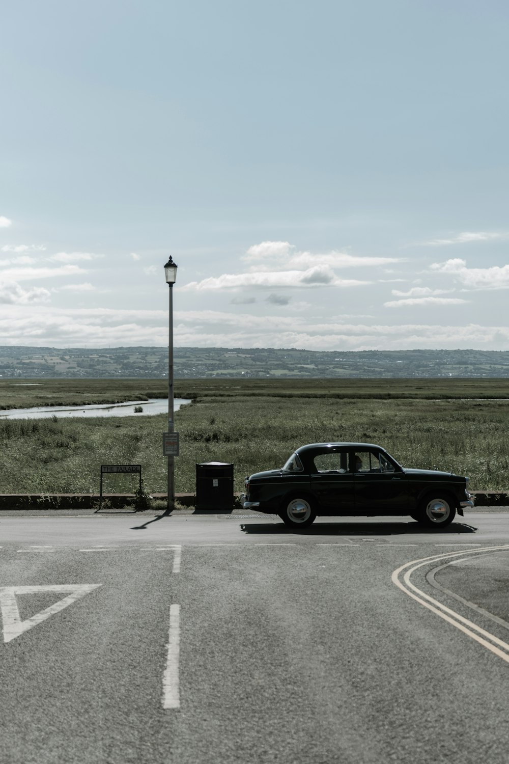 black sedan on road during daytime