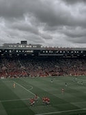 people watching football game during daytime