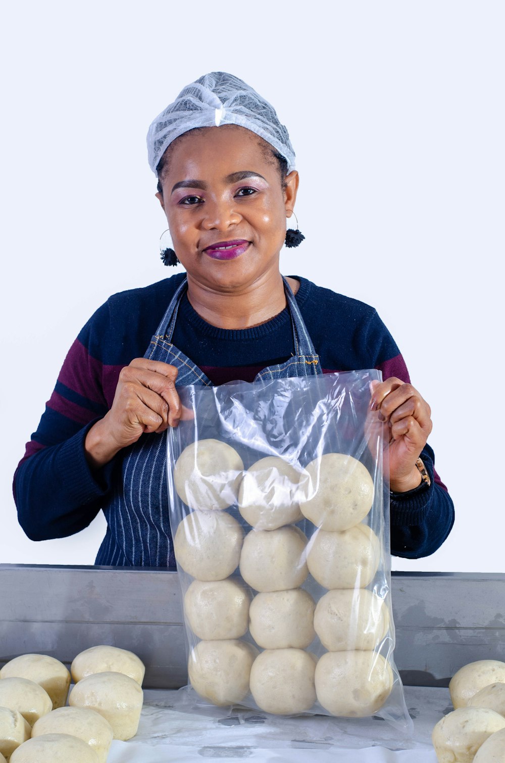 woman in maroon long sleeve shirt holding white round food