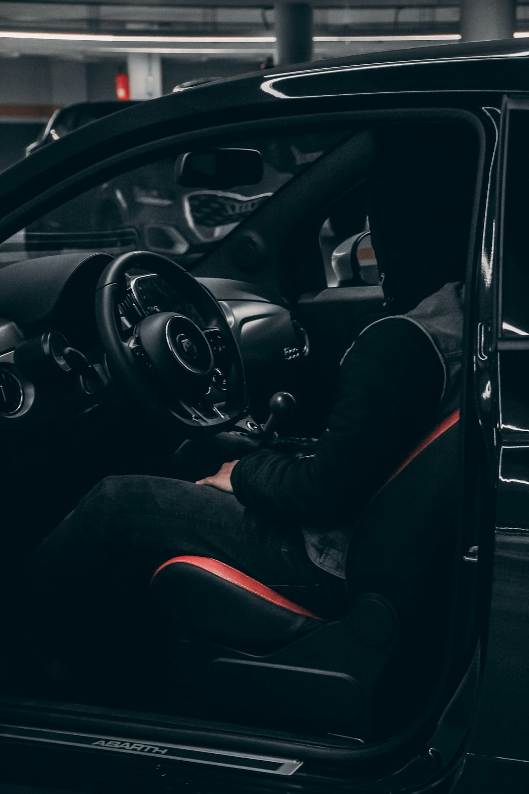 person in black jacket and black pants driving car