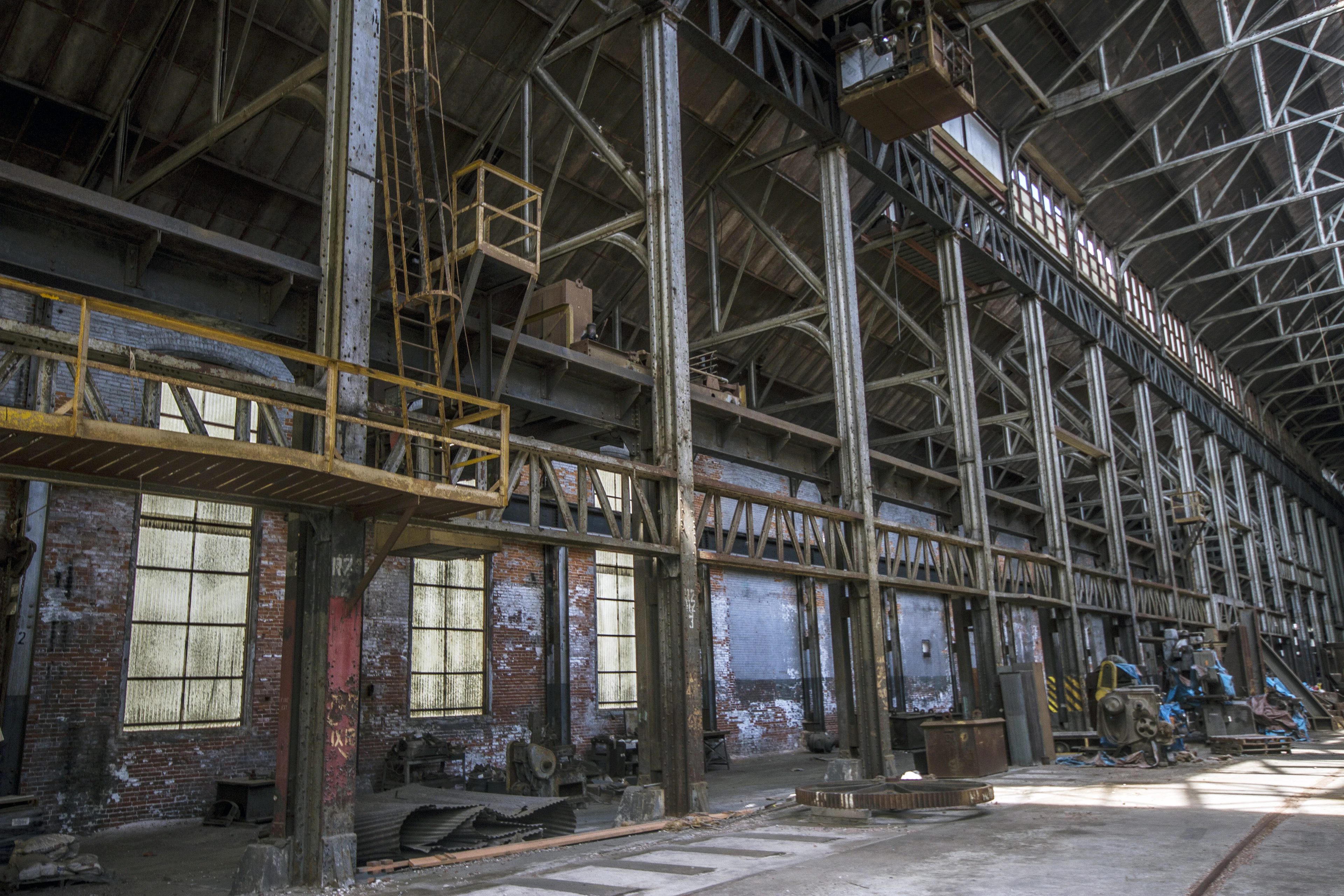 A long industrial factory hall with steel columns and high windows