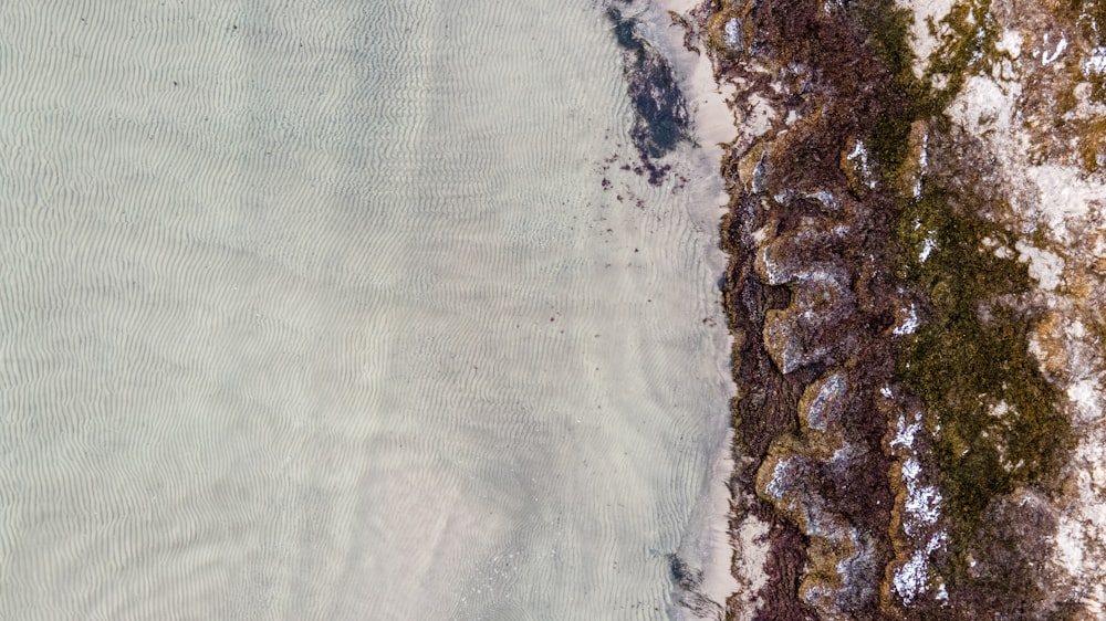 aerial view of ocean waves crashing on shore during daytime