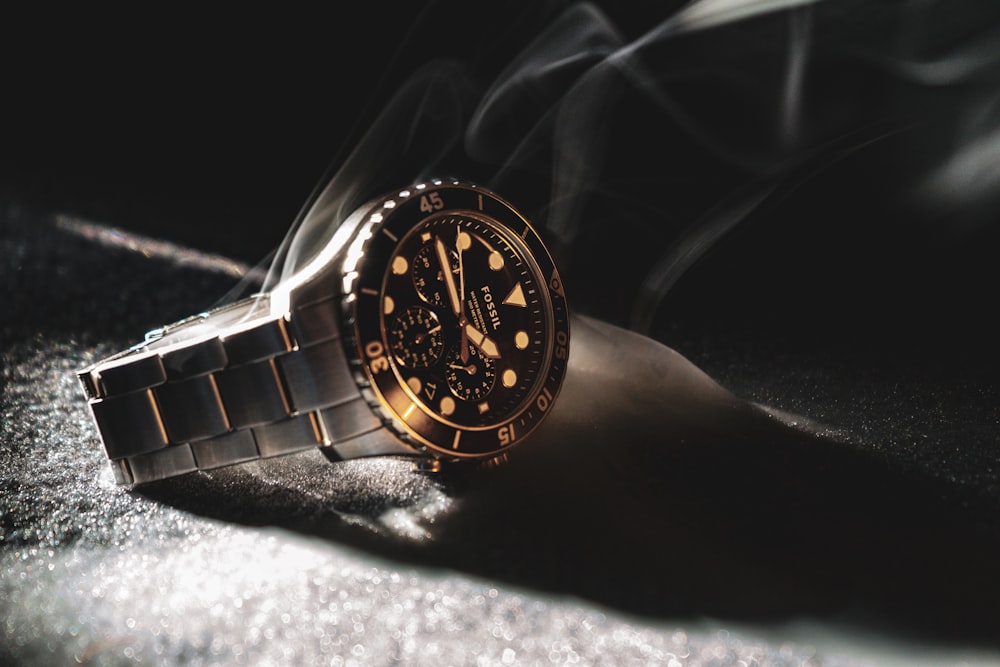 black and gold analog watch