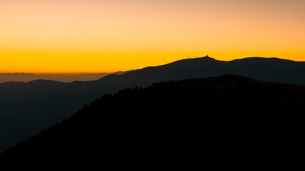 silhouette of mountain during sunset