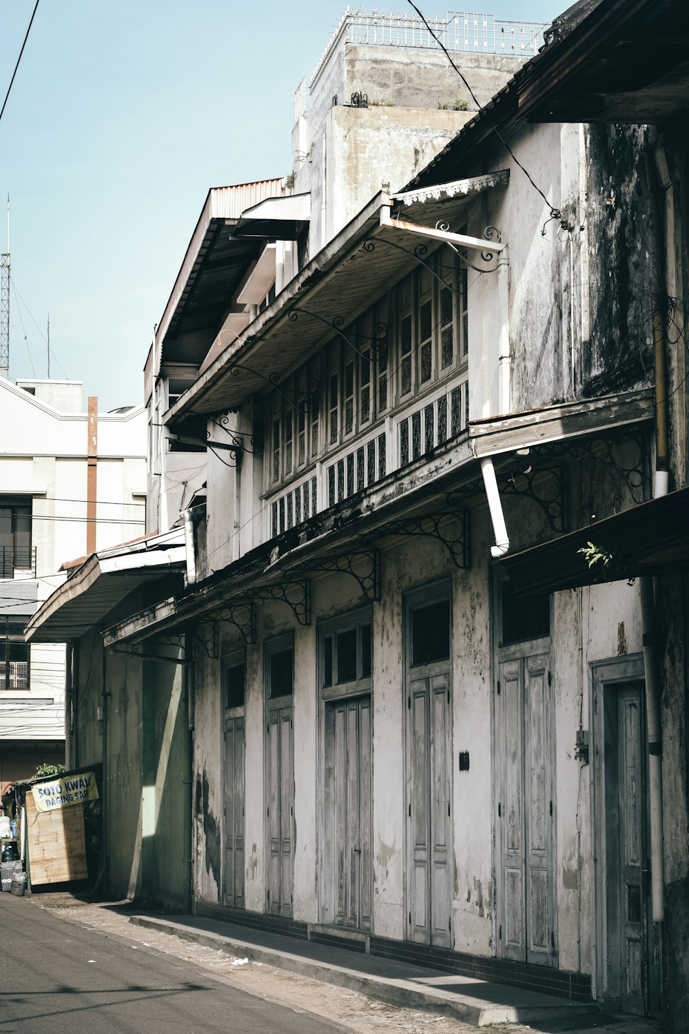 昼間の白い空の下に白と緑の木造住宅