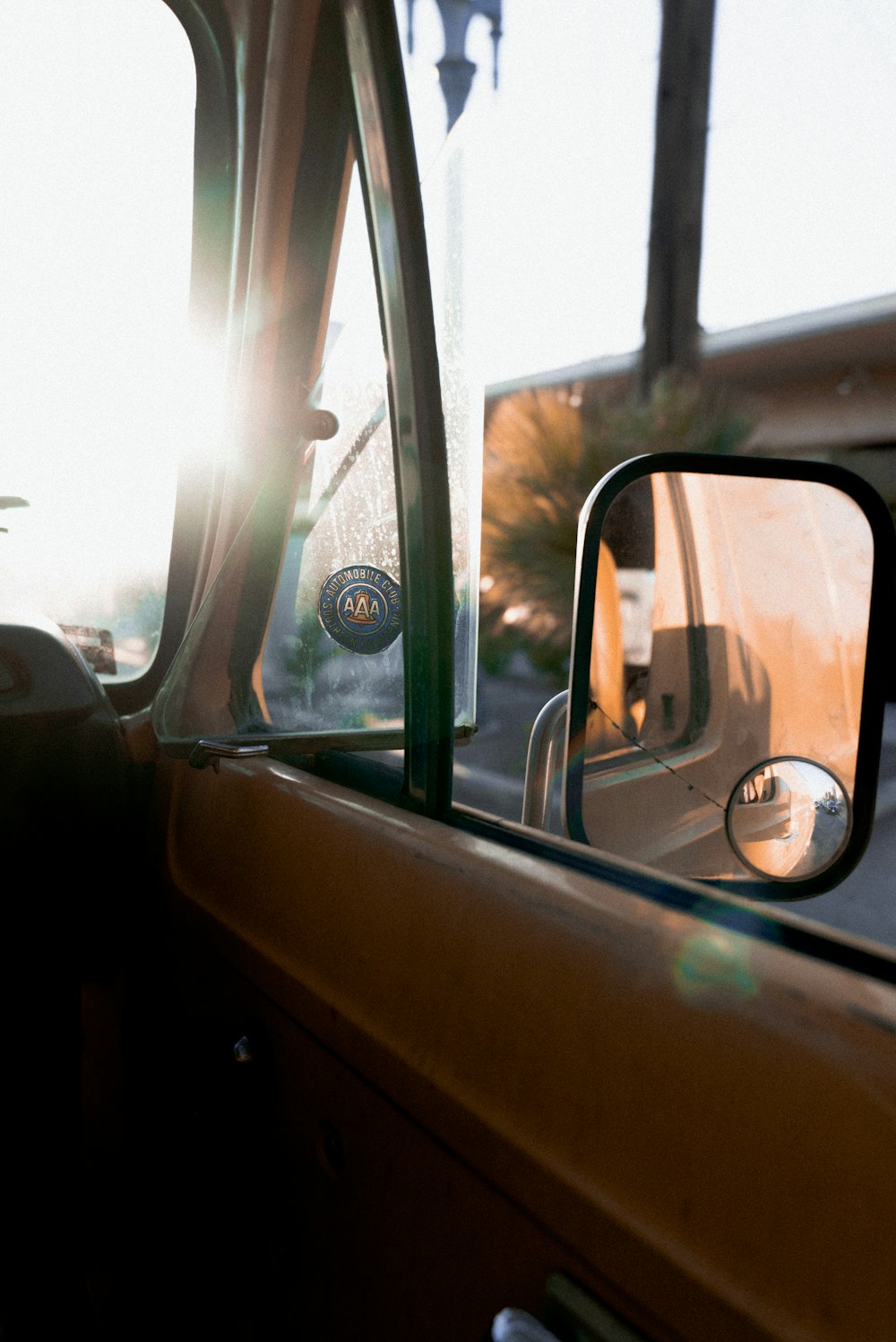 car side mirror with reflection of man in car