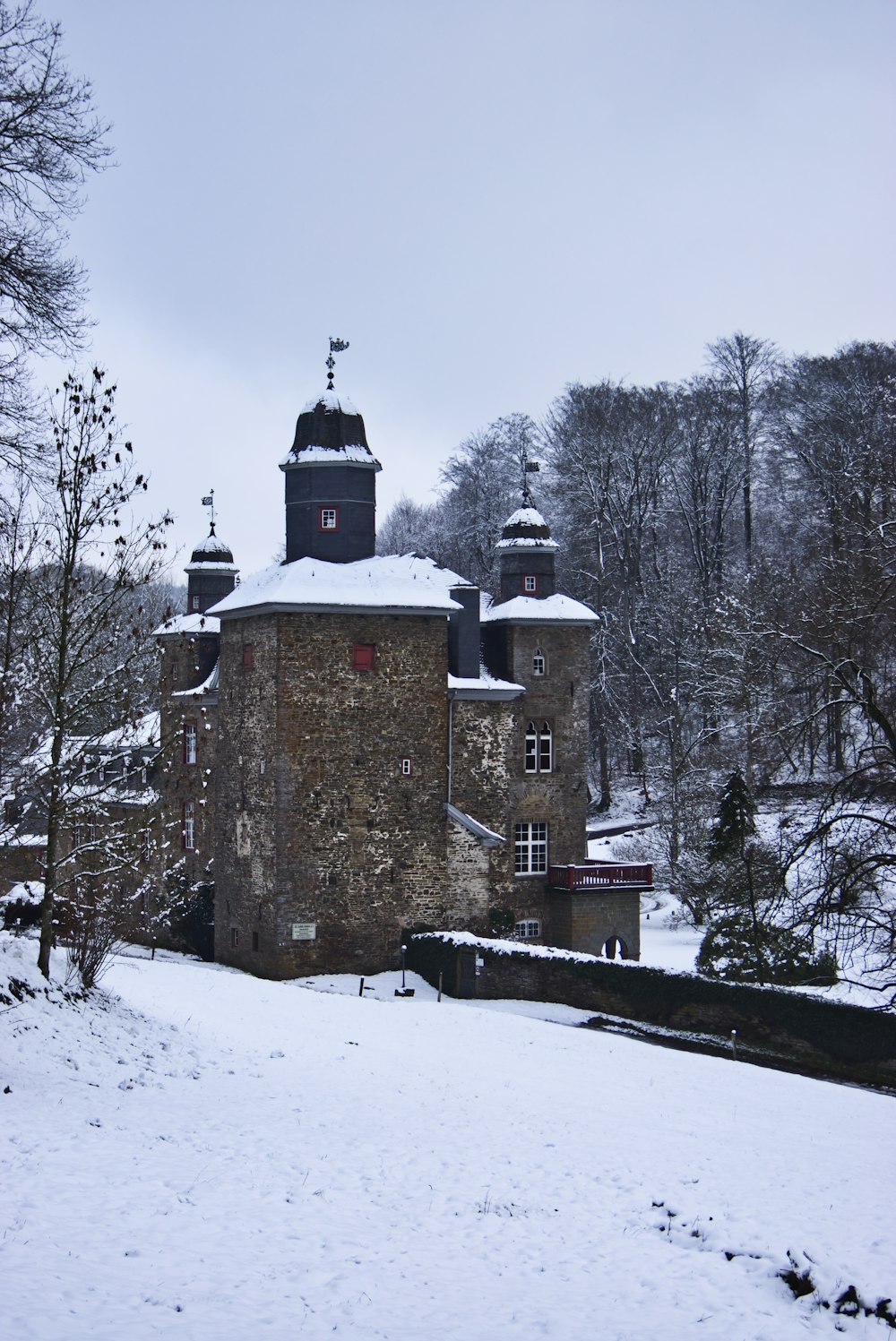 brown brick building on snow covered ground