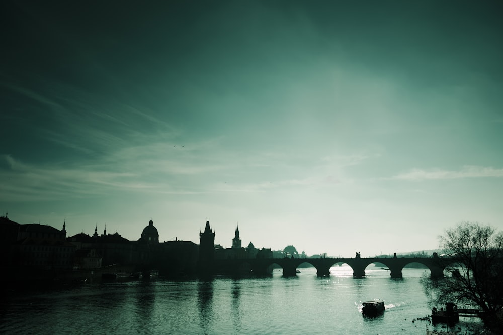 silhouette of buildings near body of water during daytime