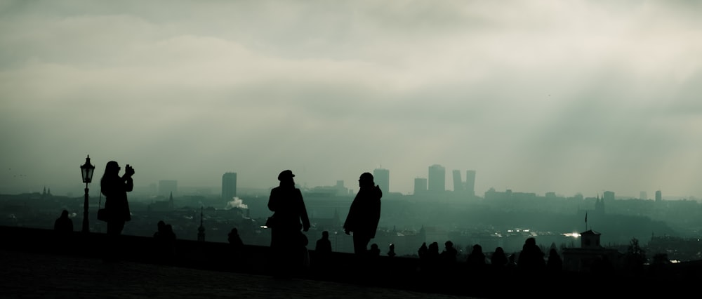 silhouette of people standing on the ground during daytime