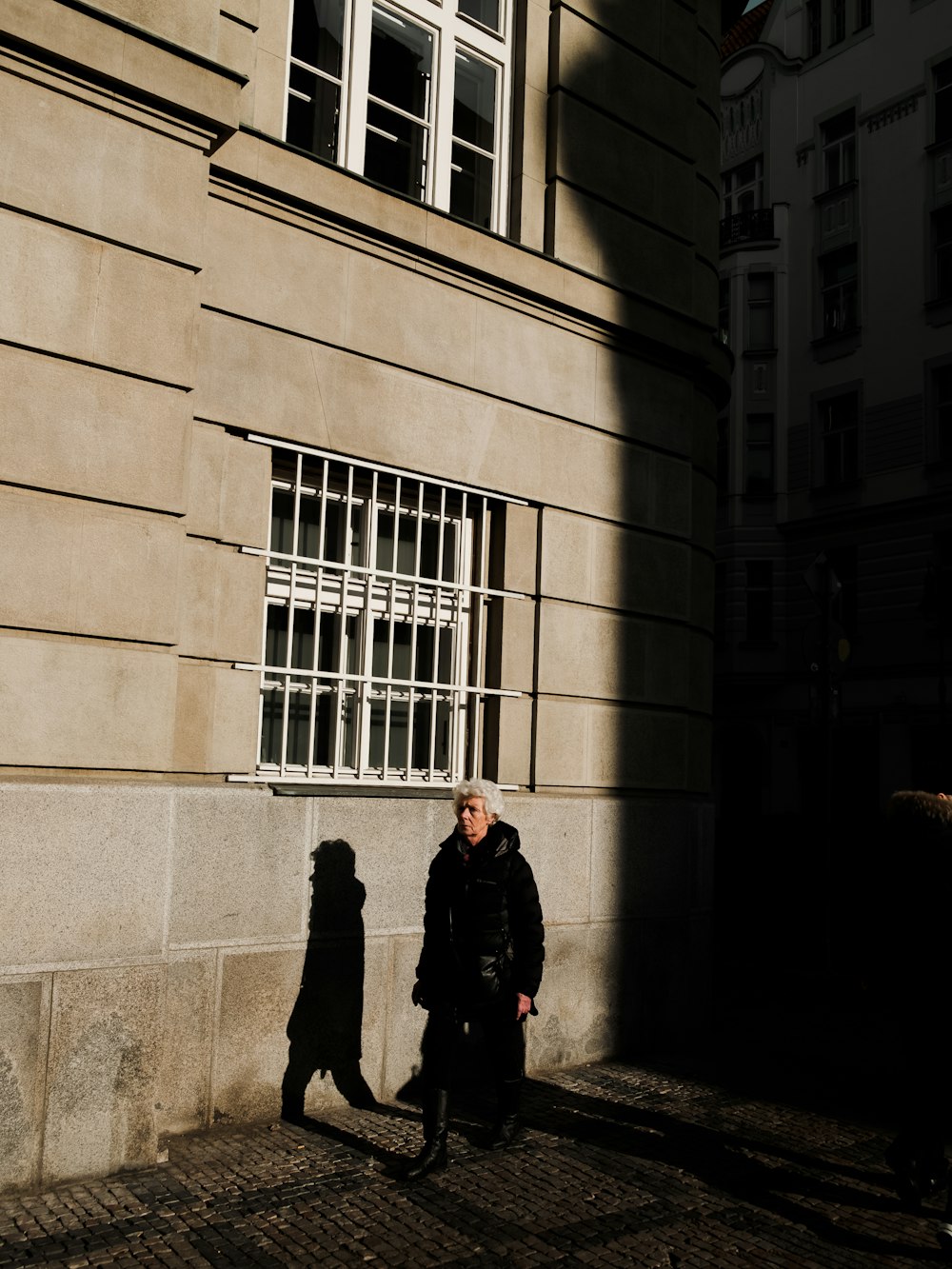 man in black coat standing beside woman in black coat