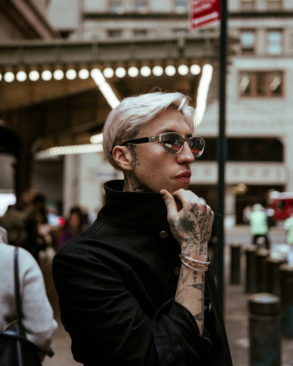 man in black leather jacket wearing white sunglasses