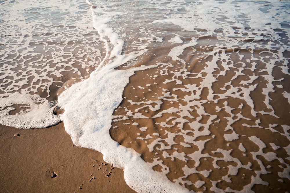 brown sand on beach during daytime