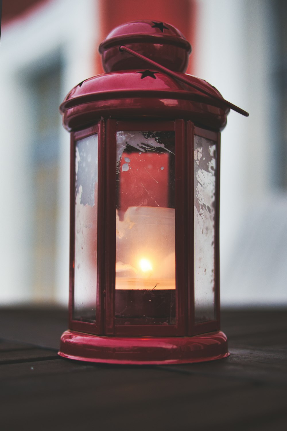 red candle lantern on white table