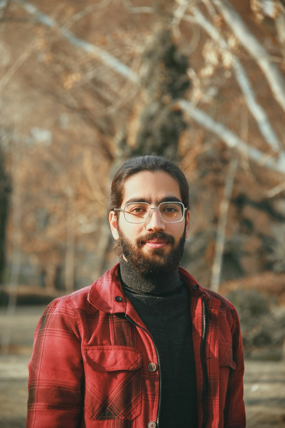 man in red and black plaid dress shirt wearing black framed eyeglasses