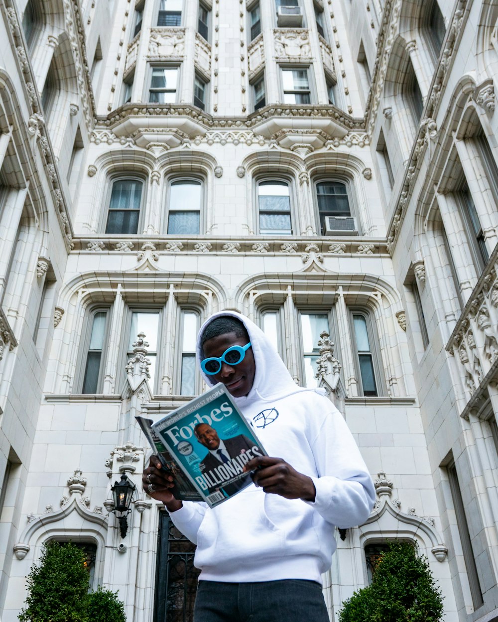 man in white thobe holding book