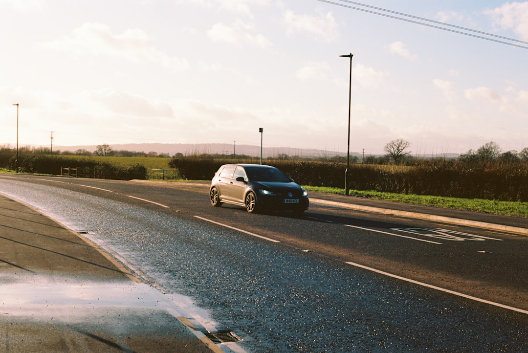 silver sedan on gray asphalt road during daytime