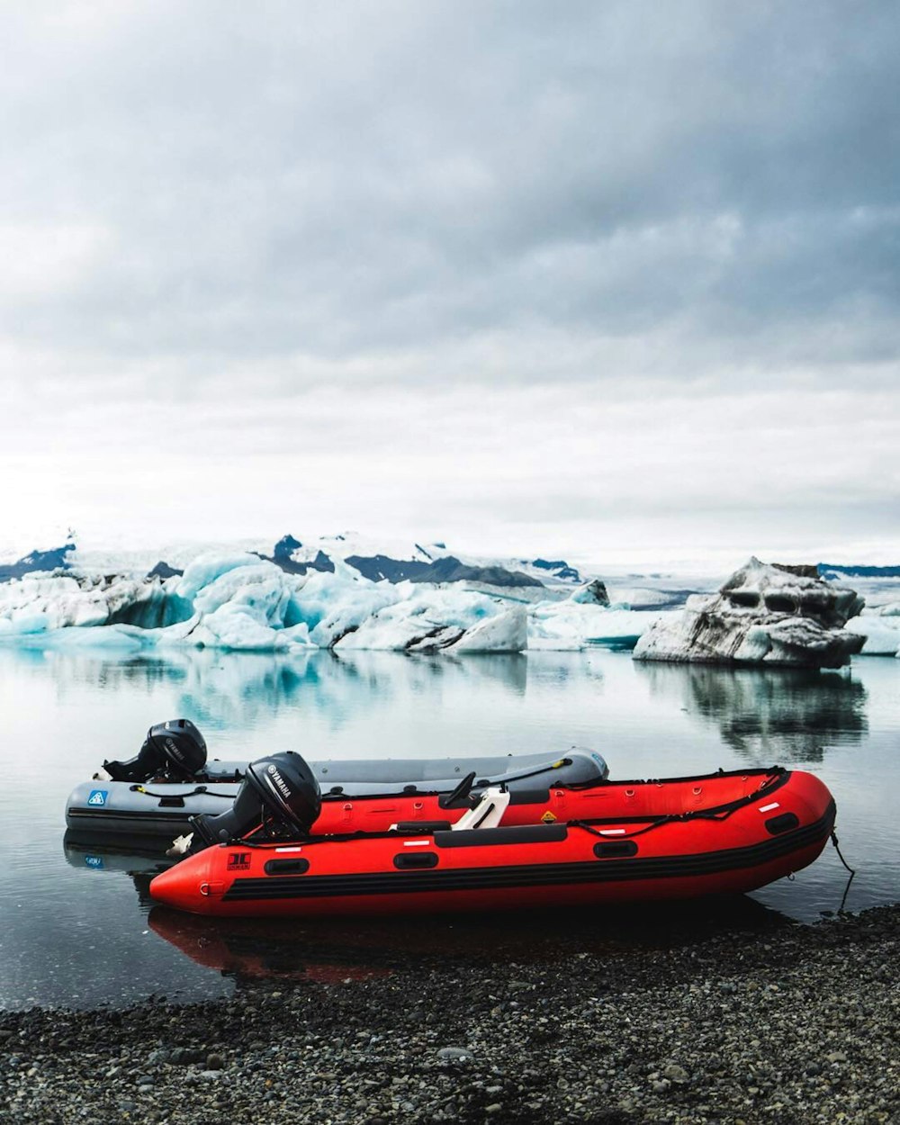 red and black kayak on body of water during daytime