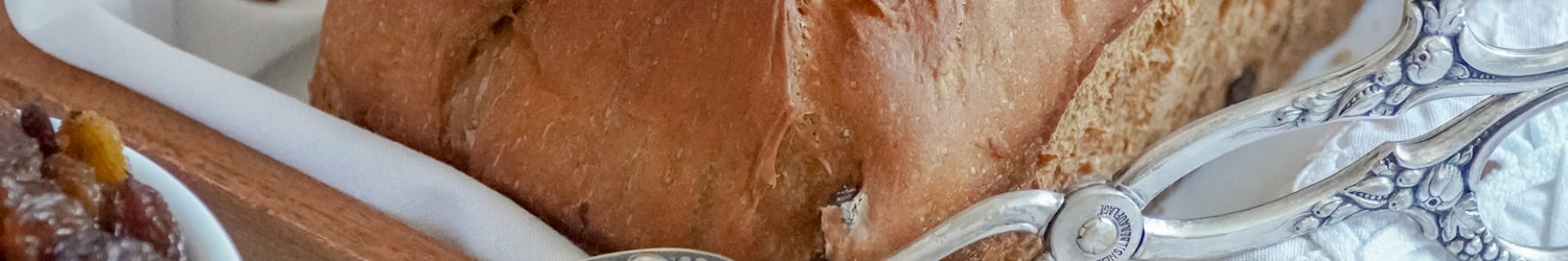 bread on white ceramic plate beside silver fork