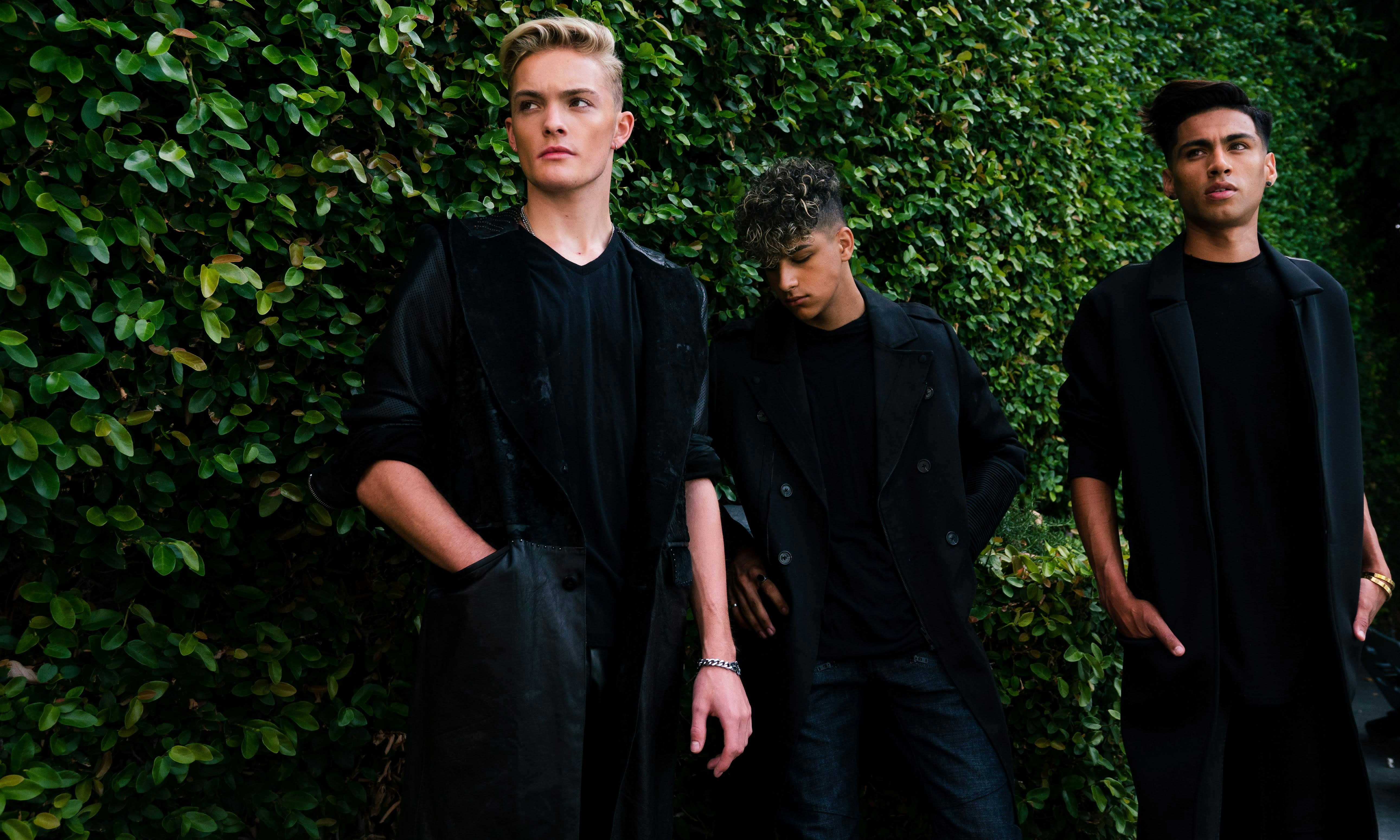 man in black dress shirt standing beside woman in black dress