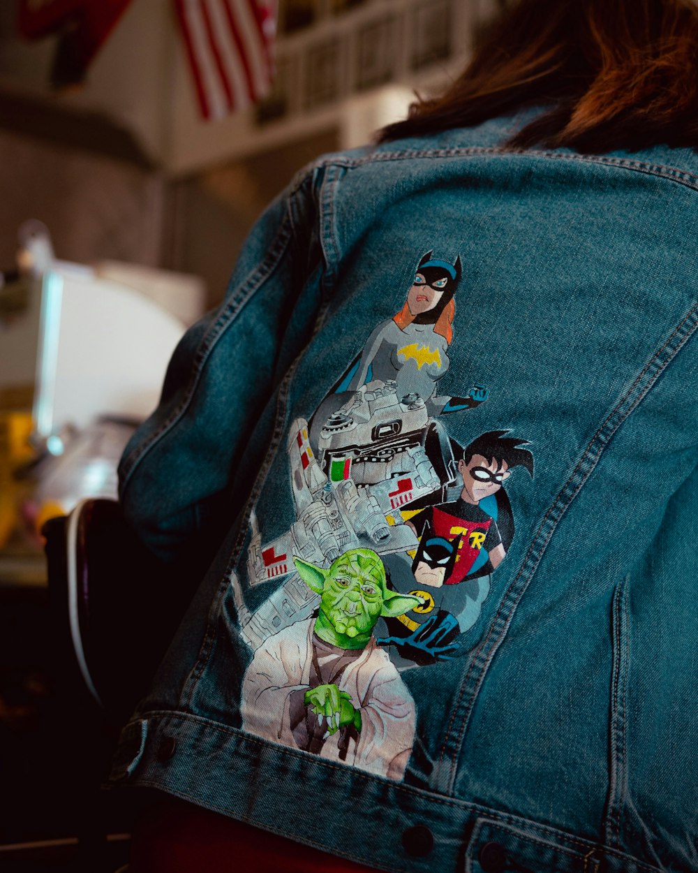 blue denim jacket with black and white penguin print