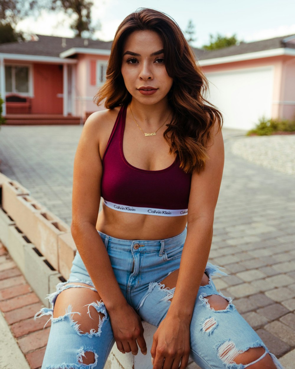 Woman in purple sports bra and blue denim shorts sitting on concrete stairs  during daytime photo – Free Apparel Image on Unsplash