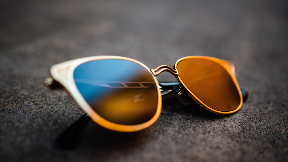 blue framed sunglasses on gray textile