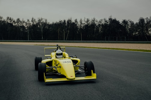 yellow and black go kart on gray asphalt road during daytime