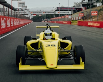 yellow and black f 1 car on road during daytime