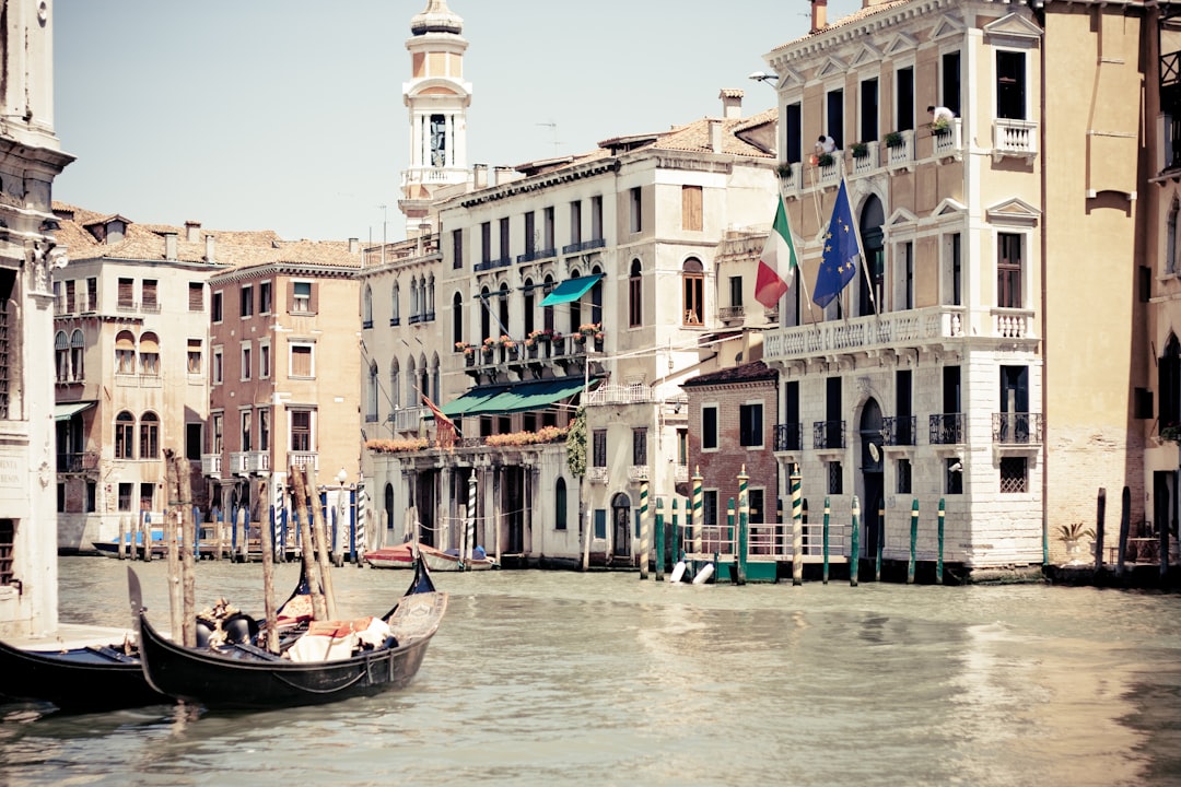 people riding on boat on river near buildings during daytime