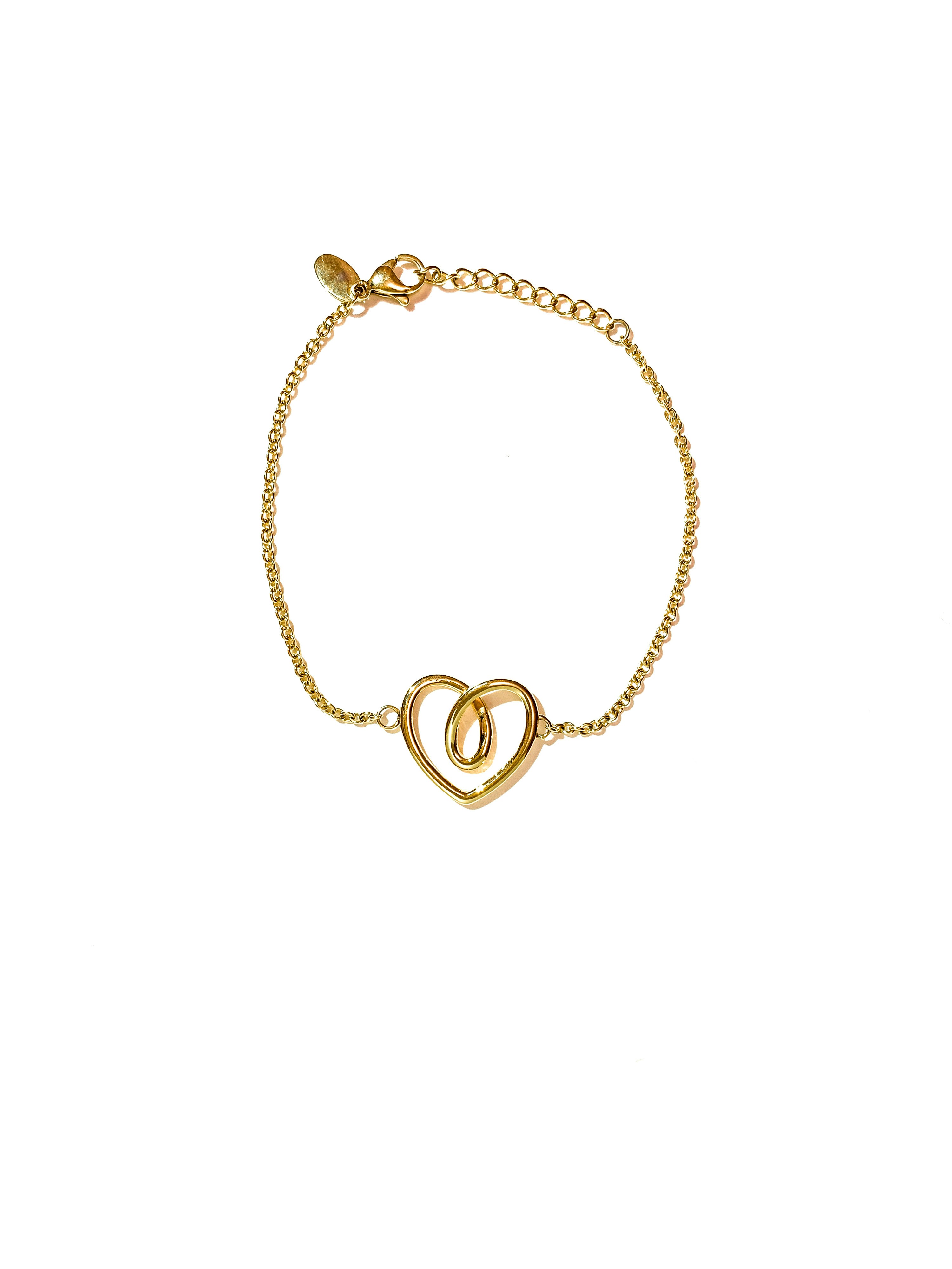 Dainty gold charm chain bracelet with small heart pendants, white background, minimalist jewelry photography