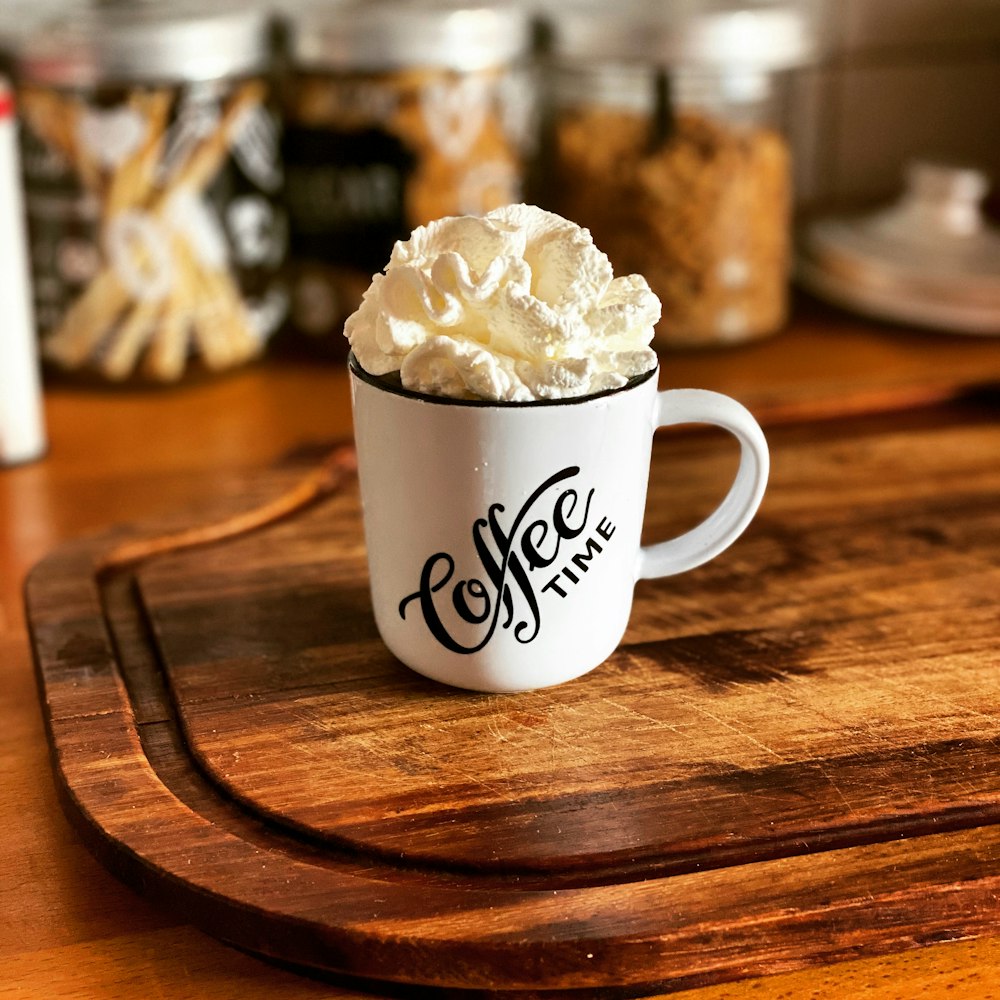 white ceramic mug with white cream on brown wooden table