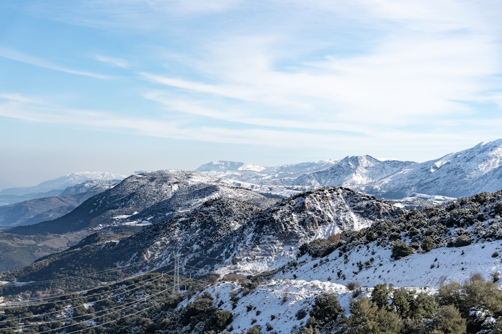 snow covered mountains under blue sky during daytime