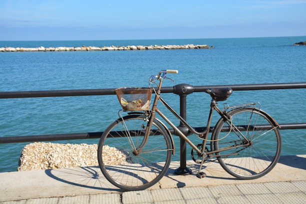 Cozy seaside hotel room with bicycle parked outside on a sunny day.