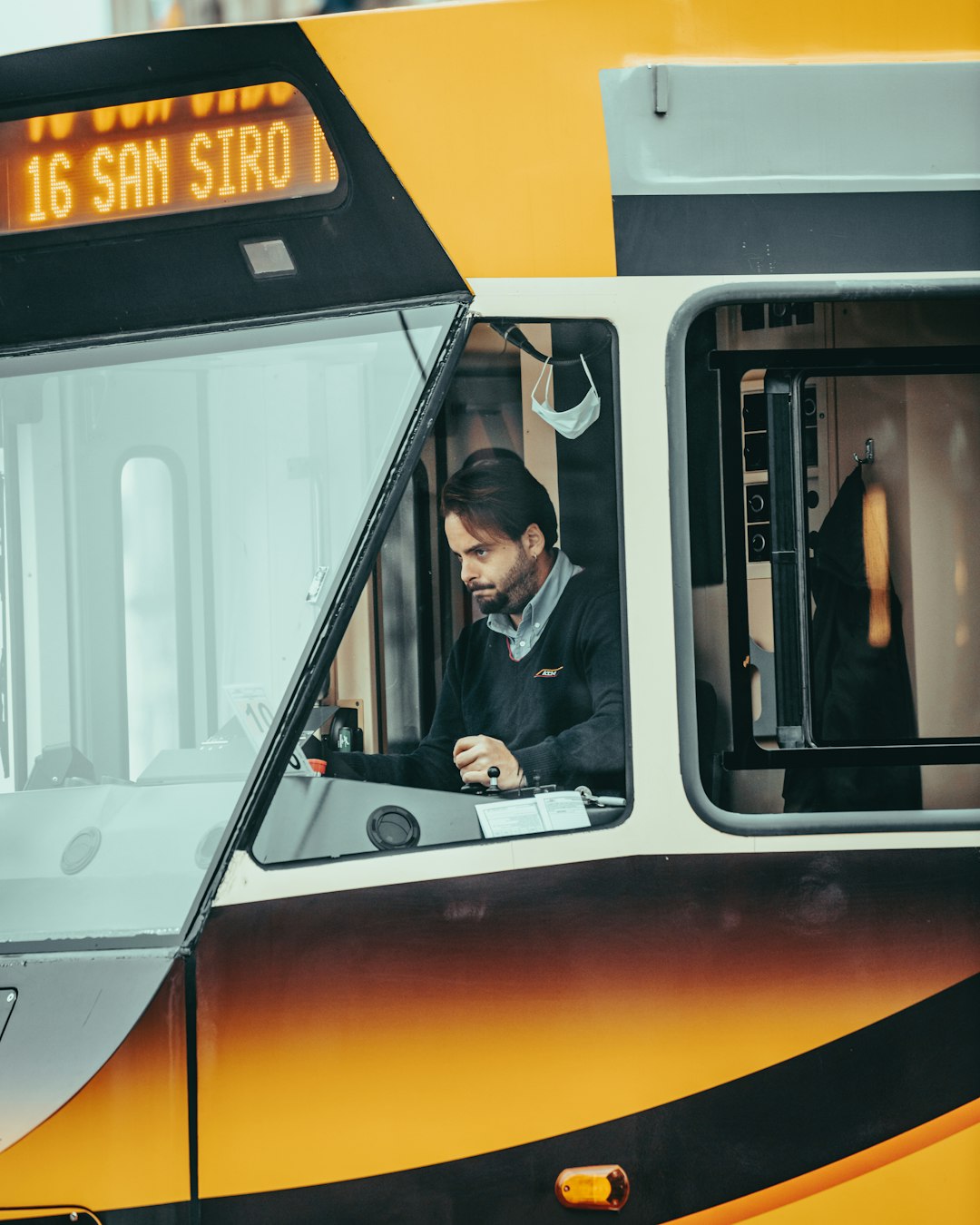 man in black jacket sitting inside train