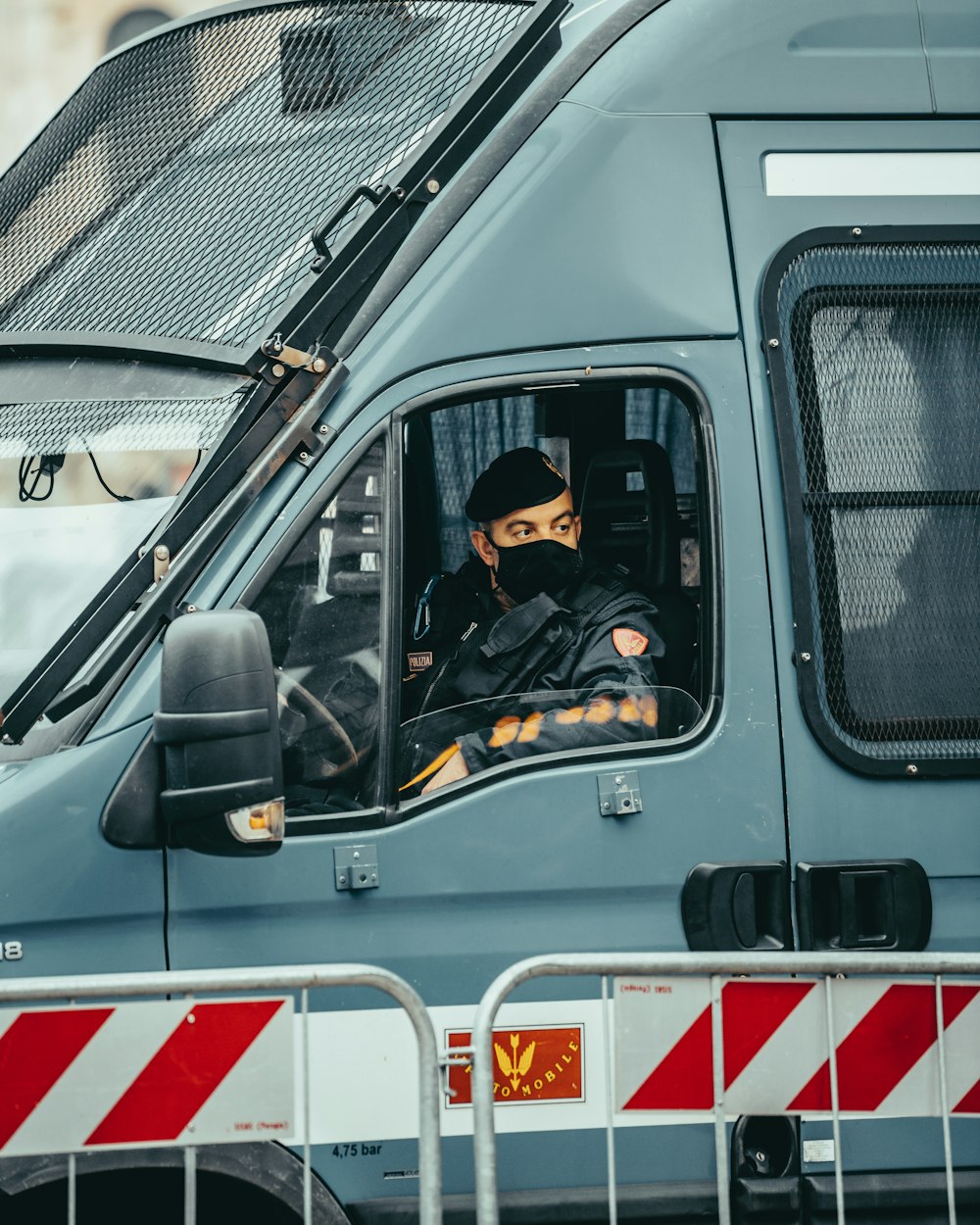 man in black jacket sitting on white van