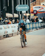 man in black helmet riding bicycle on road during daytime