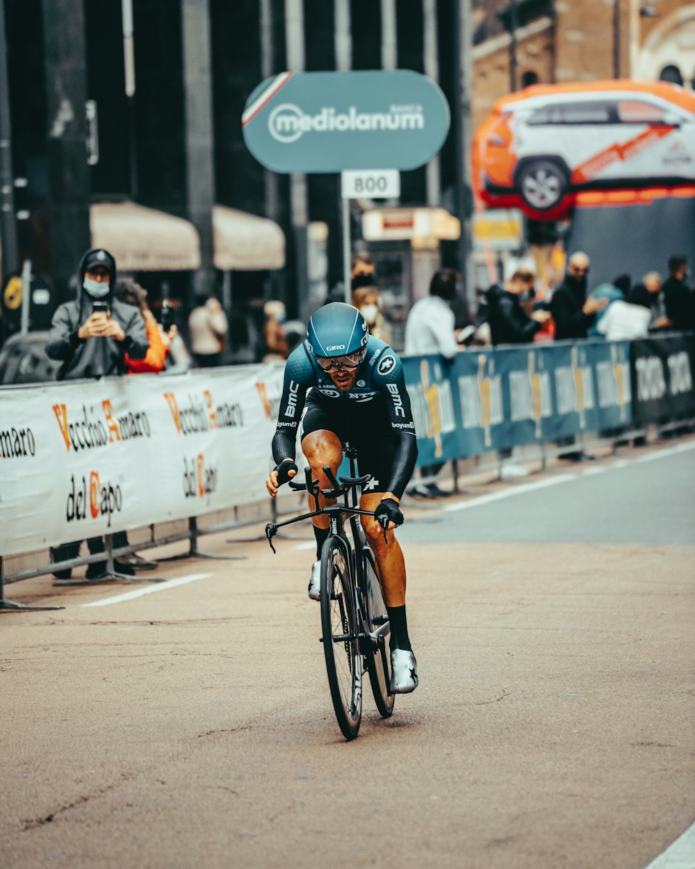 man in black helmet riding bicycle on road during daytime