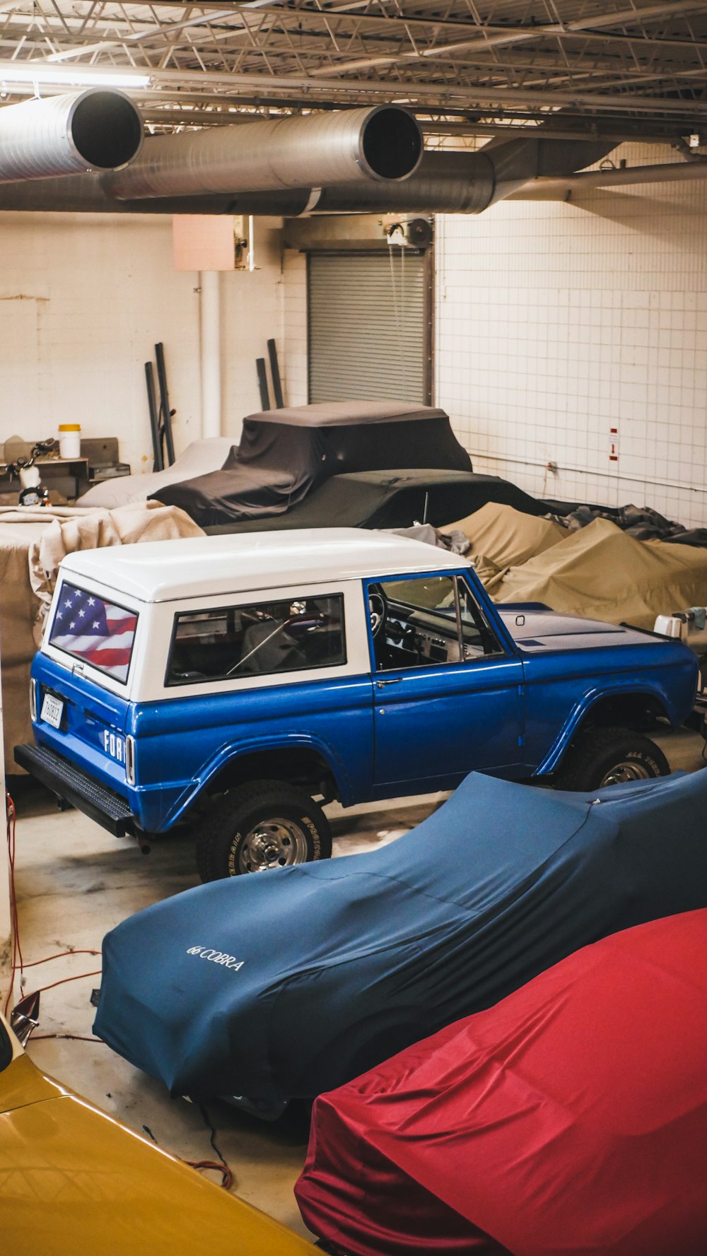 blue suv in garage during daytime