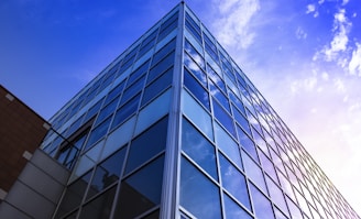 glass walled high rise building under blue sky during daytime