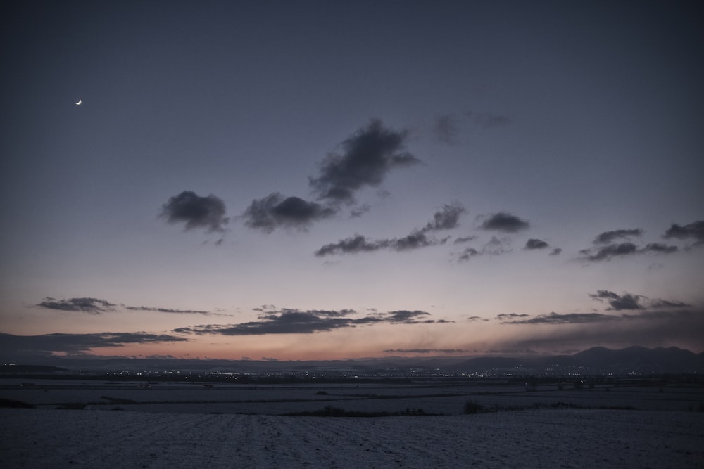 body of water under cloudy sky during sunset