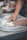 Close-up of hands shaping colorful focaccia dough sprinkled with herbs