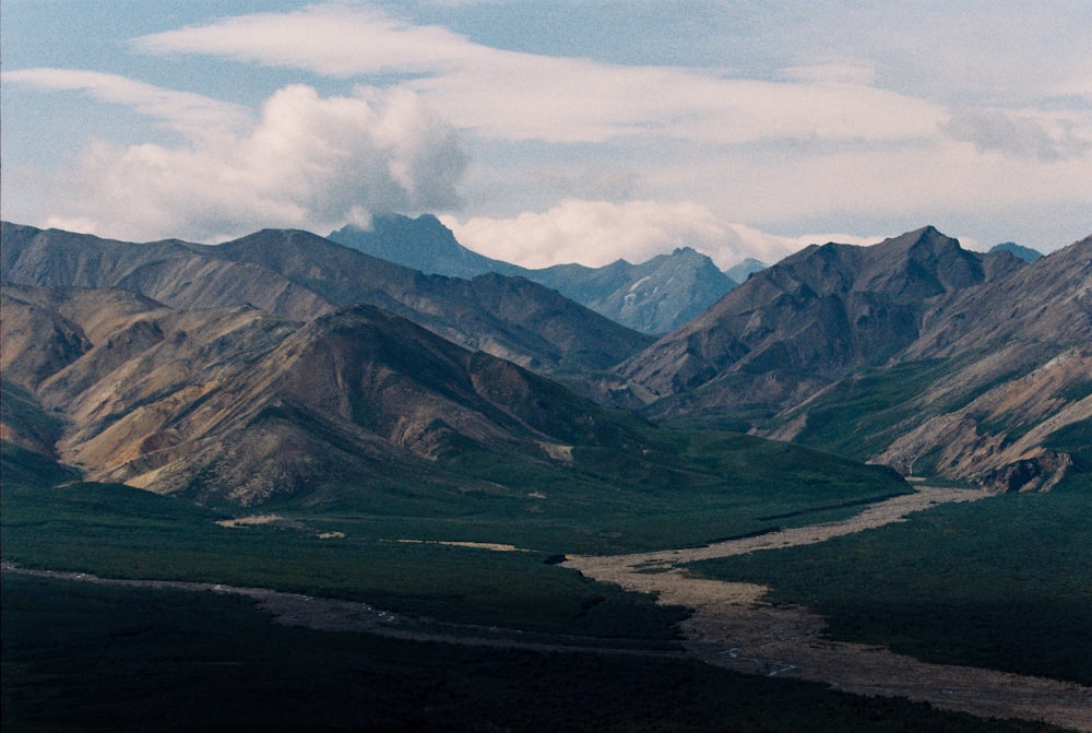 green mountains under white clouds during daytime