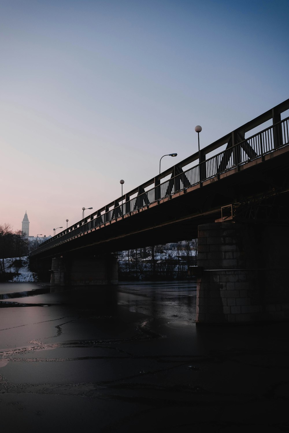 bridge over river during sunset