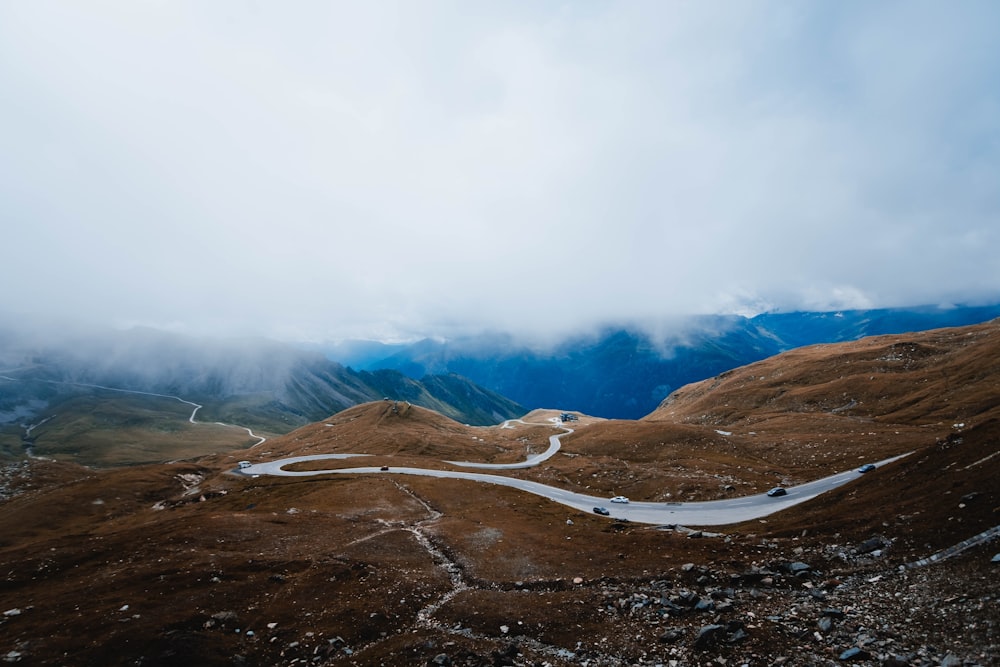 brown and white mountains under white clouds during daytime