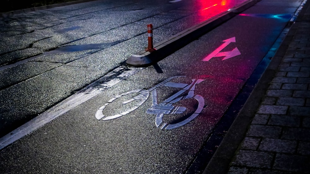 red and black traffic light on gray asphalt road