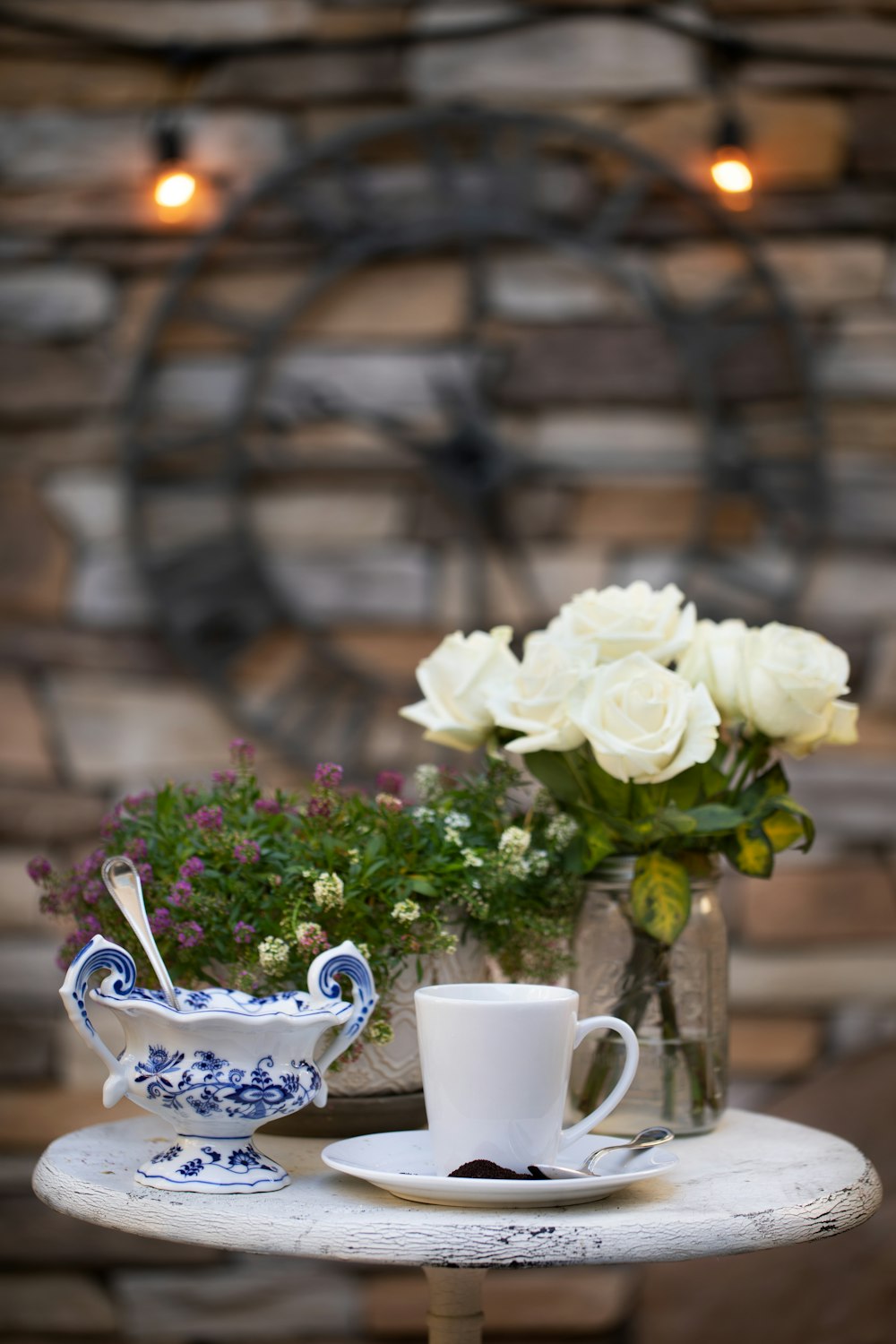 white roses in white ceramic teacup