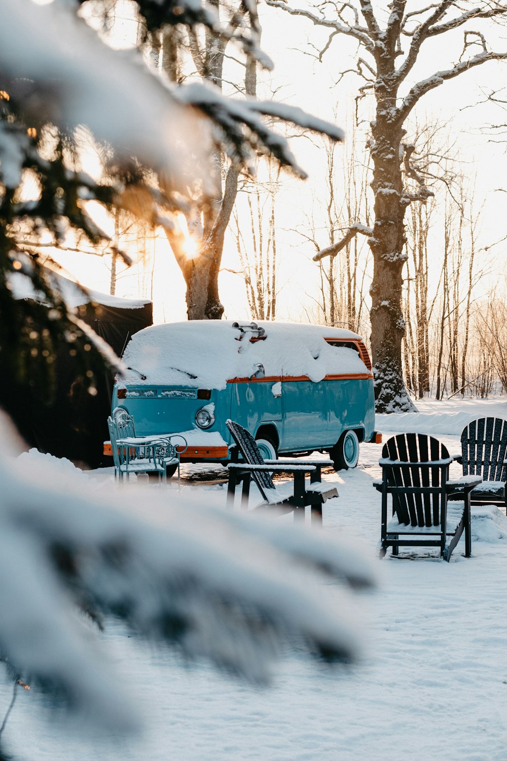 blue van on snow covered ground during daytime