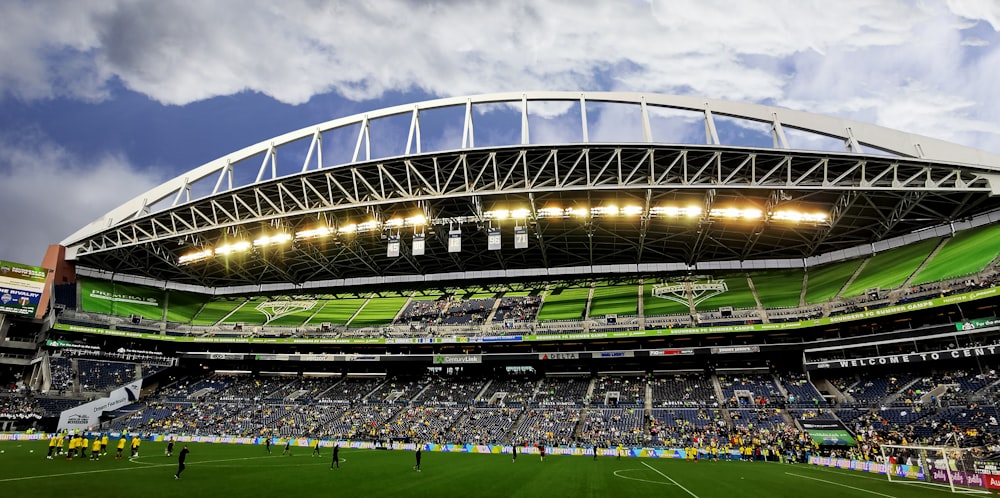 people watching soccer game during daytime