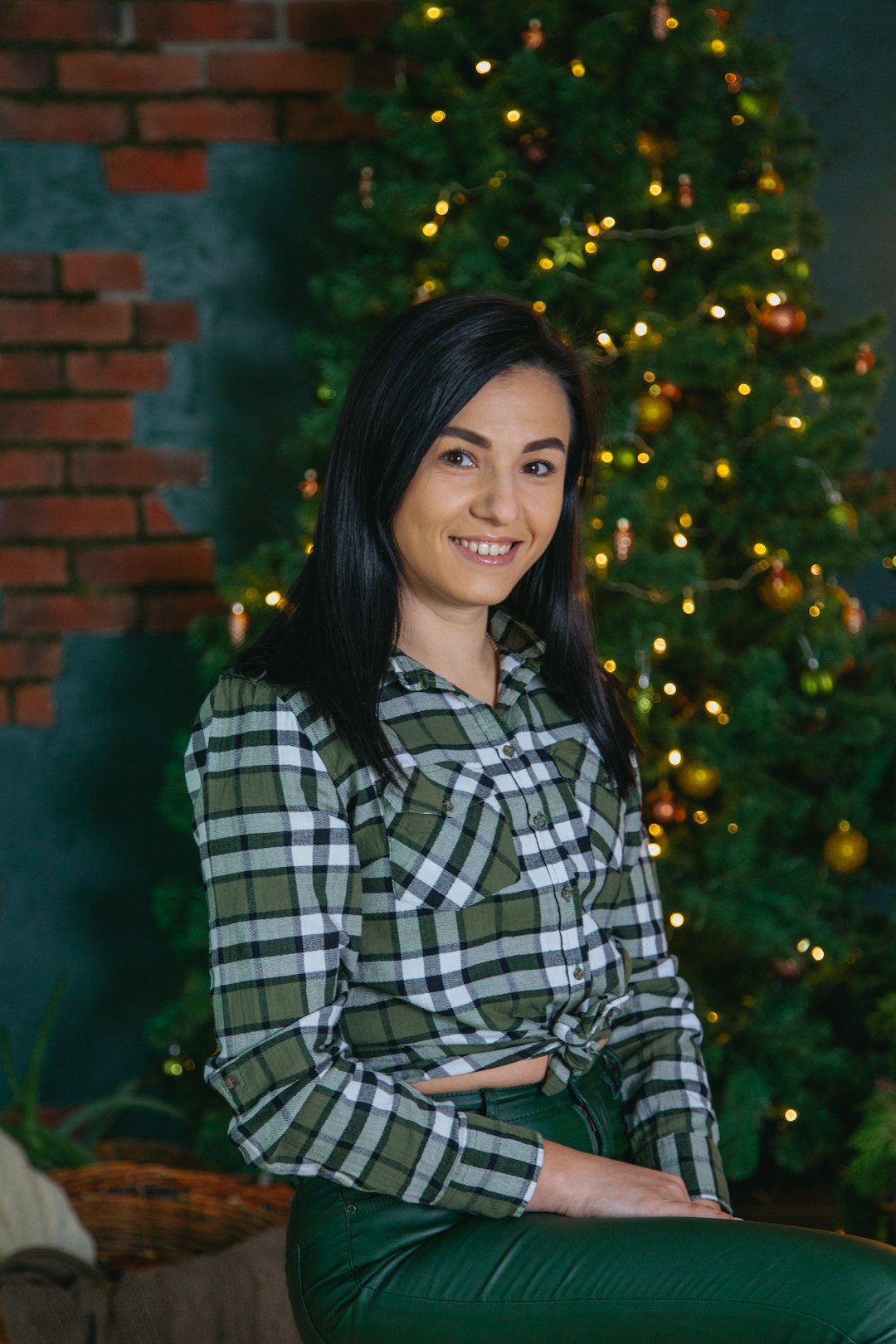 woman in black and white plaid dress shirt smiling