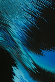 Dynamic, flowing lines in various shades of blue on a dark background create a sense of movement. The lines resemble flowing water or waves, giving an abstract and energetic feel.